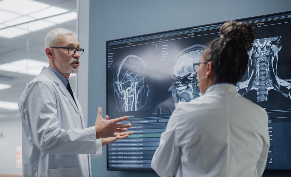 scientists reviewing brain images